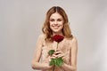 Happy woman in evening dress with a red rose in her hands Royalty Free Stock Photo