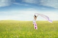 Happy woman with fabric in the meadow Royalty Free Stock Photo