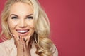 Happy woman face closeup portrait. Laughing girl on pink background, pretty face