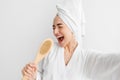 Happy woman, facial emotions, bath at home, good temper, singing song hold body brush as microphone