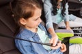 Happy woman fastening child with seat belt in car Royalty Free Stock Photo