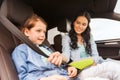 Happy woman fastening child with seat belt in car Royalty Free Stock Photo