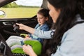 Happy woman fastening child with seat belt in car Royalty Free Stock Photo