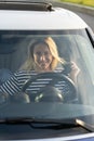 Happy woman fastening seat belt in new car. Joyful female driver vehicle owner excited to drive auto Royalty Free Stock Photo