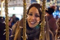 Happy woman Feeling the urban christmas vibe at night. Happy woman looking up with christmas light at night. Royalty Free Stock Photo