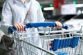 Happy woman female with closeup shopping cart or trolley in car parking of fresh maket for healthy housewife in supermarket store