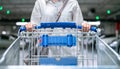 Happy woman female with closeup shopping cart or trolley in car parking of fresh maket for healthy housewife in supermarket store