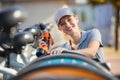 happy woman fixing bicycle Royalty Free Stock Photo
