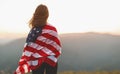 Happy woman with flag of united states enjoying the sunset on na Royalty Free Stock Photo