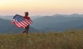 Happy woman with flag of united states enjoying the sunset on na Royalty Free Stock Photo