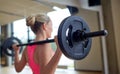 Happy woman flexing muscles with barbell in gym Royalty Free Stock Photo