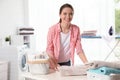 Happy woman folding clean towel at table. Laundry day Royalty Free Stock Photo