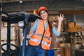 happy woman forklift staff worker work in warehouse logistics loading cargo products storage industry