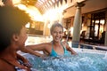 Happy woman, friends and laughing with jacuzzi for funny joke or humor at hotel, resort or hot tub spa together. Face of Royalty Free Stock Photo