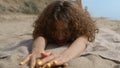 Happy woman frolicing hiding smiling face close up. Girl lying sand seashore. Royalty Free Stock Photo