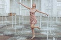 Happy woman frolics in a fountain. Royalty Free Stock Photo