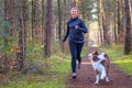 Happy woman full of vitality exercising her dog Royalty Free Stock Photo