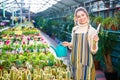 Happy woman gardener holding garden shovel and watering can Royalty Free Stock Photo