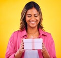 Happy woman, gift box and present for birthday, event or winning against a yellow studio background. Female person smile