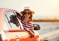 Happy woman girl goes to summer travel trip in   car Royalty Free Stock Photo