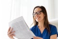 Happy woman in glasses reading newspaper at office Royalty Free Stock Photo