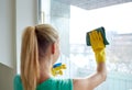 Happy woman in gloves cleaning window with rag Royalty Free Stock Photo