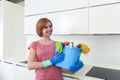 Happy woman in gloves holding cleaning bucket with cloth and household Royalty Free Stock Photo