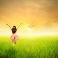 Happy woman in green rice field and sunset