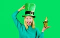 Happy woman in green top hat with small bag of gold. Patricks day celebration. Pot of money for Patrick's day party Royalty Free Stock Photo