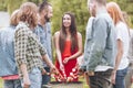 Happy woman grilling shashlik with friends during birthday party in the garden Royalty Free Stock Photo