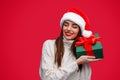 Happy woman guessing Christmas present in box Royalty Free Stock Photo