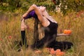 Happy woman in witch costume practicing yoga