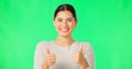 Happy woman, hands and thumbs up on green screen for agreement, good job or winning against a studio background Royalty Free Stock Photo