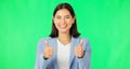 Happy woman, hands and thumbs up on green screen for success, winning or agreement against a studio background. Portrait Royalty Free Stock Photo