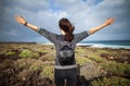 Happy woman with hands up enjoy ocean beach