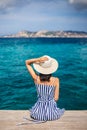 Happy woman in hat relaxing on sea pier in Sardinia island, Italy Royalty Free Stock Photo