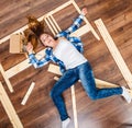 Happy woman having fun assembling furniture. Royalty Free Stock Photo