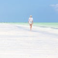 Happy woman having fun, enjoying summer, running along white tropical beach. Royalty Free Stock Photo