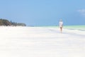 Happy woman having fun, enjoying summer, running along white tropical beach. Royalty Free Stock Photo