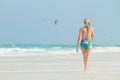 Happy woman having fun, enjoying summer, walking joyfully on tropical beach, Zanzibar, Tanzania. Royalty Free Stock Photo