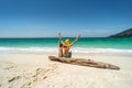 Happy woman having fun with son on a tropical beach, enjoying summer holidays, raising hands up. Tourism, family travel concept Royalty Free Stock Photo