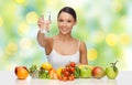 Happy woman with healthy food showing water glass