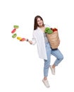 Happy woman with healthy food throw away unhealthy donuts Royalty Free Stock Photo