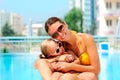 Happy woman and her daughter in pool