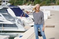 Happy woman in her 60s strolling along a seaside spot near the beach. Royalty Free Stock Photo