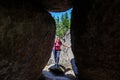 Happy woman hiker portrait , view through rocks formation. Adventure in nature