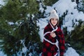 happy woman hiking outdoors in snowy mountain. Wrapped in plaid blanket. Nature and lifestyle