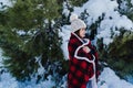 happy woman hiking outdoors in snowy mountain. Wrapped in plaid blanket. Nature and lifestyle