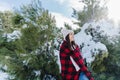 happy woman hiking outdoors in snowy mountain. Wrapped in plaid blanket. Nature and lifestyle