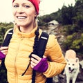 Happy woman hiking in vintage mountains with dog Royalty Free Stock Photo